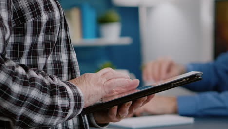 Close-up-of-woman-hands-holding-tablet-standing-in-workplace