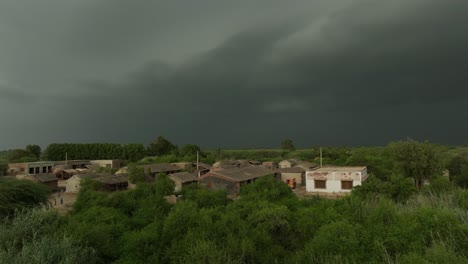 Rural-village-near-Mirpur-Khas,-Sindh,-under-stormy-skies,-from-an-aerial-perspective