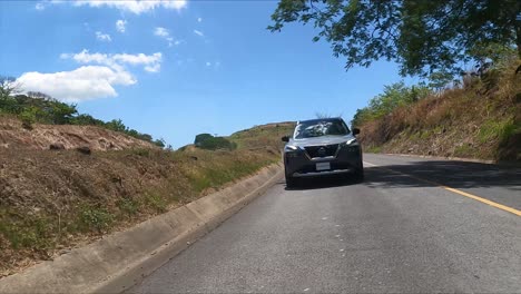 gravel-street-nissan-x-trail-driving-on-street,-compact-crossover-SUV,-Nissan-X-Trail