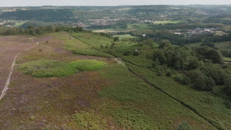Drone-flight-over-beautiful-green-countryside-and-trails,-Peak-District,-Derbyshire