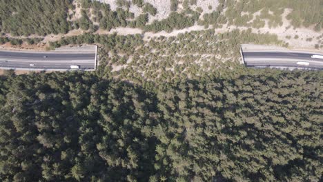 Aerial-view-of-the-road-and-tunnel-passing-through-the-mountains,-the-natural-vegetation-of-Bosnia