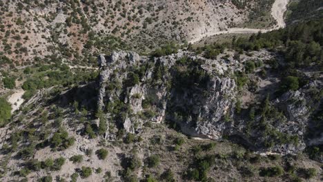 Drone-shot-of-the-giant-canyon-formed-between-two-large-mountains,-view-of-the-path-passing-through-the-canyon