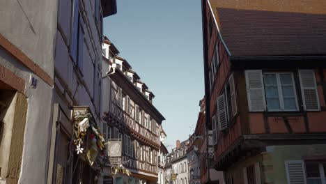 Beautiful-half-timbered-buildings-in-medieval-town-in-France,-Small-street-view-Colmar