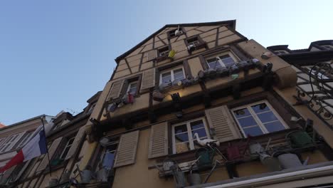 Beautiful-decorated-half-timbered-house-in-medieval-town-in-France,-Low-angle-view