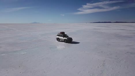Tracking-shot-of-a-vehicle-driving-through-the-Bolivian-Salt-Flats