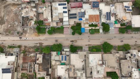 Aerial-top-down-shot-of-a-street-in-Mirpur-Khas,-Sindh,-lined-with-buildings