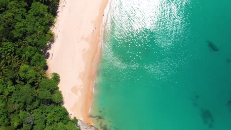 Orbit-drone-shot-of-the-pristine-beachfront-of-Leam-Singh,-an-untouched-piece-of-paradise-on-the-west-coast-of-Phuket-island-in-the-southern-part-of-Thailand