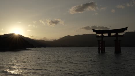 Floating-torii-gate-of-Itsukushima-Shrine-at-sunset,-Japan