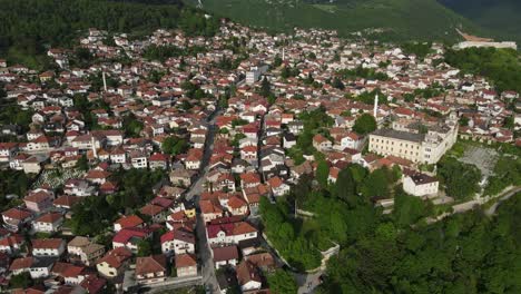 Aerial-drone-view-of-a-Bosnian-city-in-the-Balkans,-mosques-and-old-buildings-among-the-houses