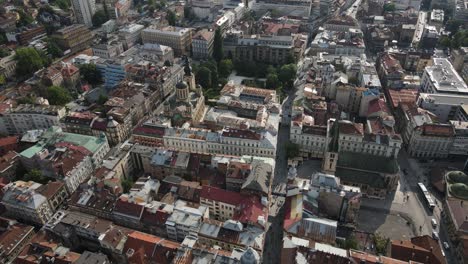 Aerial-view-of-the-streets-of-the-city-of-Sarajevo,-the-view-of-the-city-of-Sarajevo-the-capital-of-Bosnia-with-tile-roofs-historical-buildings-and-street-roads