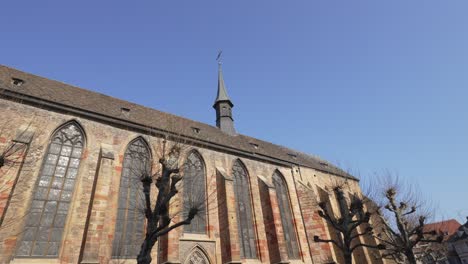 Scenic-wide-angle-shot-of-a-roman-catholic-church-in-Colmar,-architectural-building