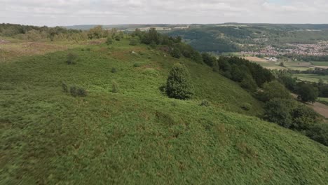 Drone-over-green-hills-and-moorland,-Peak-District,-British-countryside