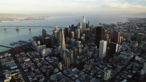 Aerial-view-away-from-the-sunlit-city-center-of-San-Francisco,-golden-hour-in-USA