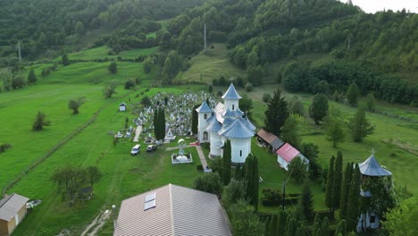 Aerial-View-Of-An-Ancient-Church-And-Cemetery-In-Palanca,-Bacau-County,-Western-Moldavia,-Romania