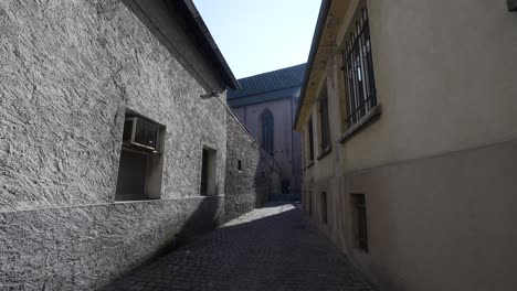 Gobblestone-small-street-leading-to-the-catholic-church-of-Saint-Joseph-in-Colmar,-France