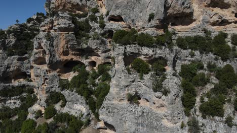 Drone-view-of-hollow-caves-in-the-mountain,-image-of-perforated-rock-structure