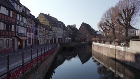 Wide-view-of-the-La-Lauch-tiver-flowing-through-the-medieval-town-of-Colmar-with-half-timbered-houses