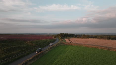 Cars-driving-on-British-country-lane,-Summer,-drone-footage