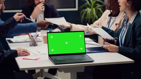 Business-people-meeting-in-a-boardroom-office-with-greenscreen-display
