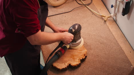 Woodworking-specialist-uses-angle-grinder-on-wood,-close-up-shot