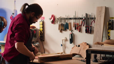 Handwerker-In-Der-Tischlerei-Mit-Schraubstock-Werkzeug-Zum-Einspannen-Stück-Holz