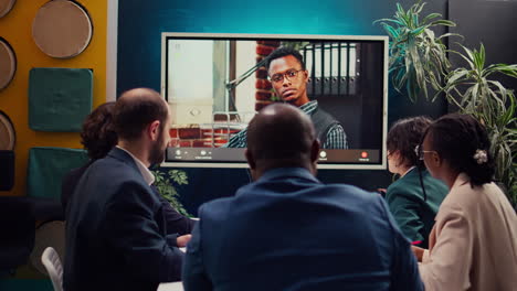 Management-team-meeting-with-CEO-on-videocall-connection-in-a-boardroom