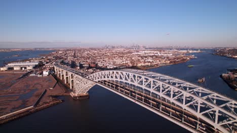 Pristine-aerial-of-Bayonne-Bridge,-Staten-Island,-Route-440,-New-York-City-skyline-on-horizon