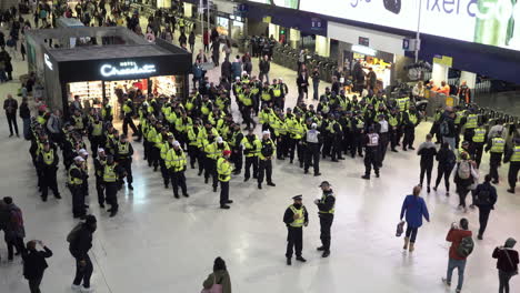 Metropolitan-and-British-Transport-Police-line-up-into-units-prior-to-making-arrests-at-a-pro-Palestine-sit-down-protest-in-Waterloo-train-station