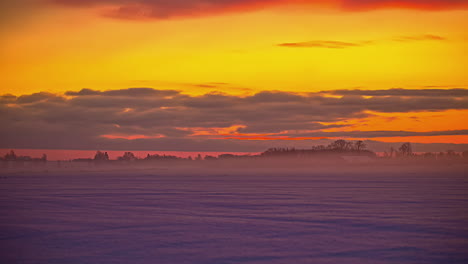 Time-lapse-morning-mist-and-clouds-moving-in-snowy-winter-rural-Riga,-Latvia