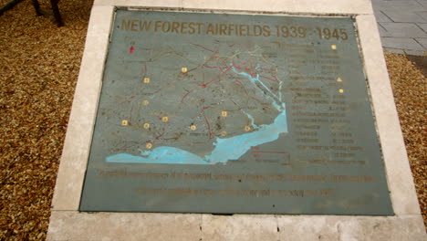Panning-Mid-shot-of-the-memorial-plaque-showing-the-map-of-the-airfields-at-the-New-Forest-Airfields-Memorial-in-the-New-Forest