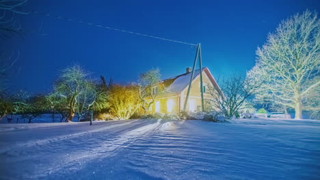 Time-lapse-house-in-snowy-forest-at-night,-moving-stars-rural-Riga,-Latvia