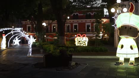 Schwenkaufnahmen-Von-Weihnachtsbeleuchtung-Und-Dekorationen-Im-Hauptpark-Von-Puebla-City,-MX