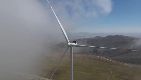 Drone-view-of-wind-energy-systems-installed-on-the-tops-of-mountains,-renewable-energy-source