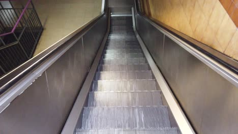 Automatic-Silver-Staircase-Underground-Going-Down,-Descending-Metallic-Escalator