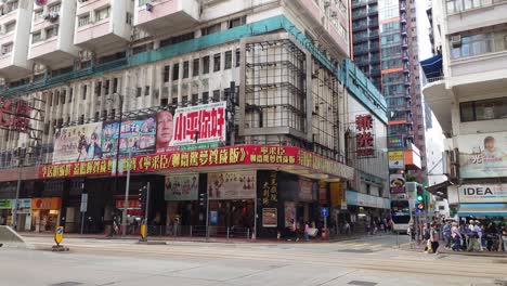 The-Sunbeam-Theatre-Building-At-North-Point,-Hong-Kong-With-Traffic-Going-Past