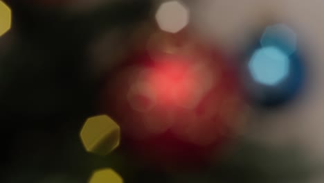 Red-glittery-christmas-ball-tree-doceoration-slowly-coming-into-focus