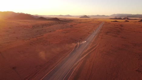 Namibian-self-drive-wildlife-adventure-with-a-rooftop-tent-equipped-Toyota-Hilux-in-Sossusvlei's-iconic-sand-dunes-at-sunset
