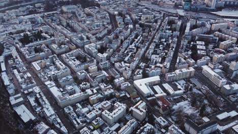 Bird's-eye-view-of-city-buildings-covered-in-snow-in-Winter,-Salzburg,-Austria