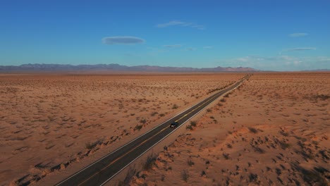 Car-driving-in-the-desert-on-a-road-from-California-to-Arizona