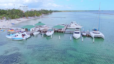 Aerial-view-showing-parking-boats-and-yacht-on-jetty-of-Playa-Boca-Chica,-Dom