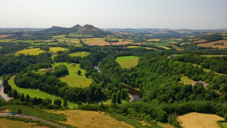 Aerial-Pan-of-Scottish-Countryside-on-Summer's-Day,-The-River-Tweed-and-Eildon-Hills,-Scottish-Borders,-Scotland