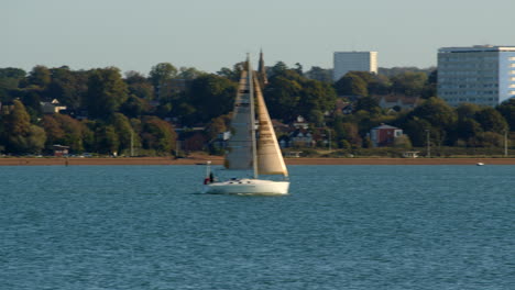 Planning-shot-of-Weston-tower-blocks-with-small-sailboat-sails-in-to-frame-at-Solent-Southampton