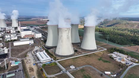 Aerial-view-of-nuclear-power-plant-cooling-towers-emit-white-smoke-in-atmosphere