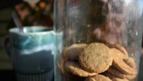 Enjoying-hot-drink-and-cookies-on-terrace-in-autumn,-cozy-moment-close-up