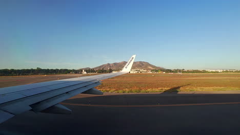 A-Moving-Aeroplane-Shot-From-The-Window-And-An-Open-Landscape-With-A-Mountain-Spain