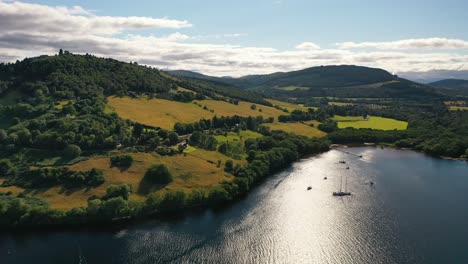Views-of-Scotland,-Aerial-Pan-of-Scottish-Landscape-To-Urquhart-Castle-Over-Loch-Ness-in-the-Scottish-Highlands