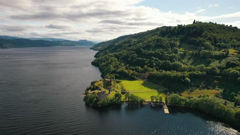 Aerial-Over-Loch-Ness-and-Urquhart-Castle-on-Cloudy-Summer-Day,-Scottish-Highlands