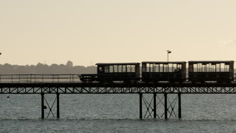 Hythe-Pier-Railway-train-in-silhouette-going-right-to-left-of-frame
