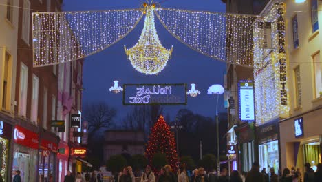 Handheld-tilt-up-to-big-Christmas-chandelier-in-Dublin-shopping-street