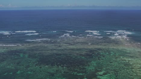Aerial-footage-of-a-shallower-blue-lagoon-of-corals-in-the-ocean